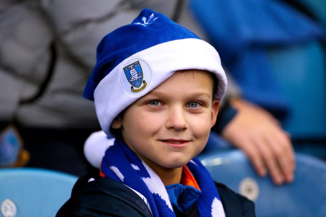A young Wednesday fan sports a Santa hat during the game with Bristol City at Hillsborough in December 2019.