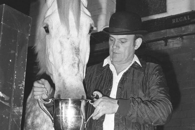 Bob Stobbart lets Regal, one of the Vaux horses, have a drink out of one of the trophies that he helped to win at the Royal Show in Windsor in 1988.