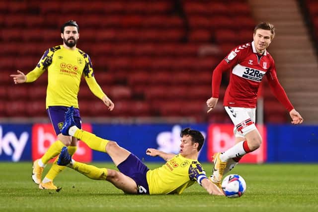 Jonathan Hogg of Huddersfield Town lays on the floor as Duncan Watmore of Middlesbrough looks on.