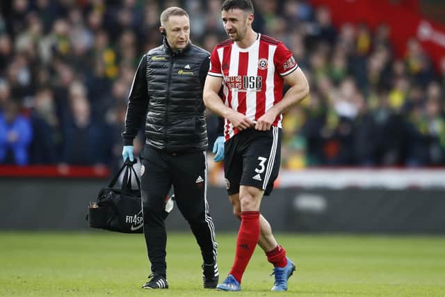 Enda Stevens of Sheffield United goes off injured during the Premier League match against Norwich City at Bramall Lane: Simon Bellis/Sportimage