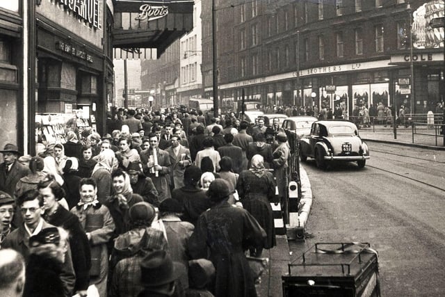 The junction of Fargate and High Street is busy with shoppers, December 17, 1955