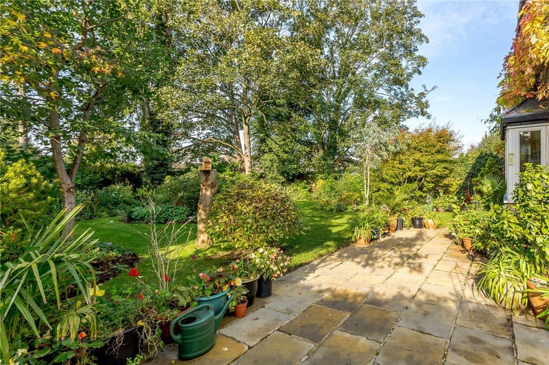 Beautiful mature gardens surround the property, and the outside space also includes a large gravel driveway and a double garage, which is currently fitted as a studio.