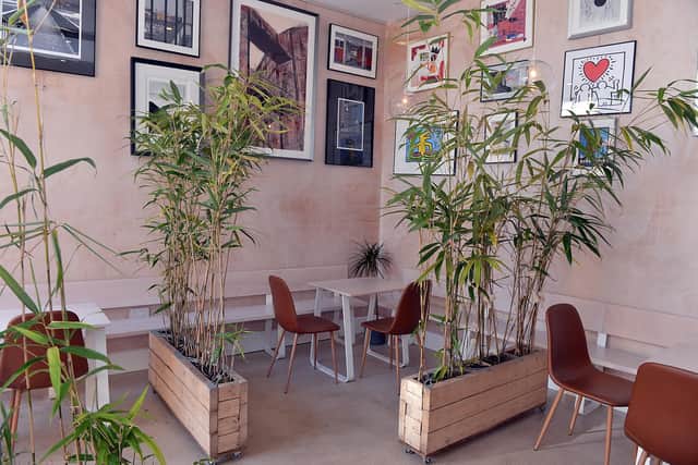 Art lines the walls and tasteful plants divide the tables inside The Framery on Sharrow Vale Road. Picture: Brian Eyre.