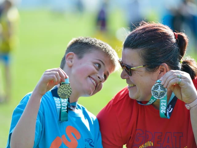 Big smiles as this young lad shows off his medal. Photo: Peter Langdown