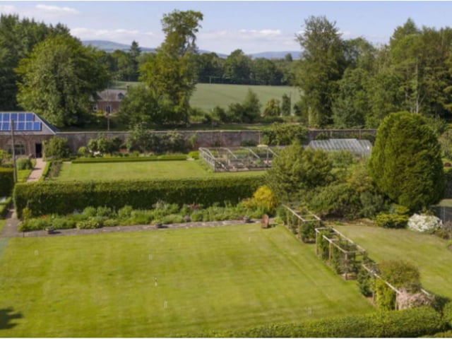 The formal gardens include a paved terrace, richly planted herbaceous borders, roses and expanses of lawn including directly in front of the castle.