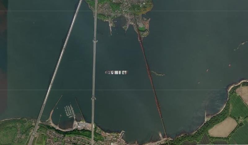 This shows the Ever Given hanging around the Forth Bridges, looking massive.