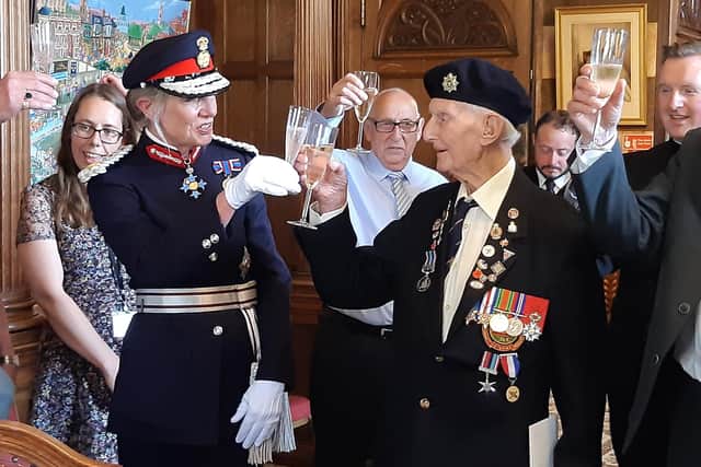 One of Sheffield's last remaining Normandy Veterans from World War Two, Cyril Elliott, accepts a toast from the Lord Lieutenant of South Yorkshire, Dame Hilary Chapman