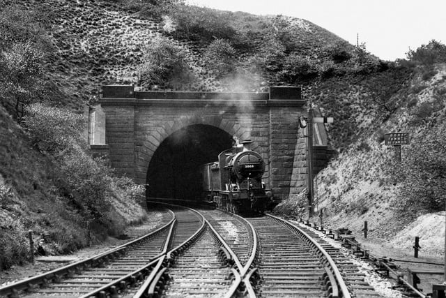 Halfway from Dronfield, trains enter Bradway Tunnel, which is one mile 266 yards long. North of it is the short 91-yard Dore Tunnel - here's a train passing its north portal in about 1935.
