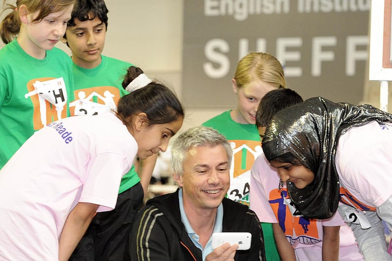 Olympic triple jump champion Jonathan Edwards CBE with pupils of Westways School, Crookes (in green) and Whiteways Primary, Firvale (pink) during his visit to the Arches Games held at the English Institute of Sport, Sheffield
