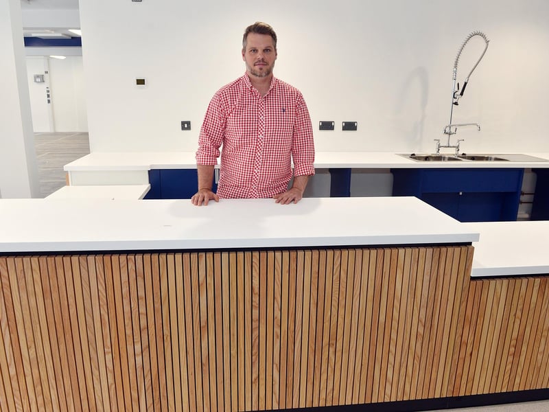 Krzysztof Urbaniak, who will run the new Moor Cafe inside the market, stands behind the café.counter.