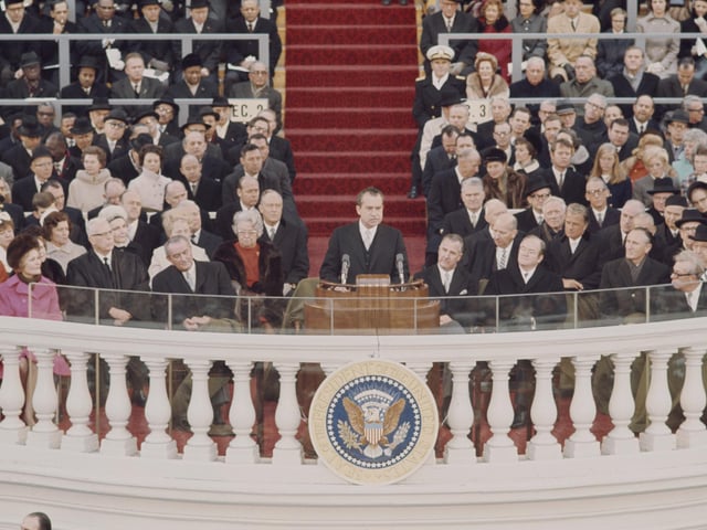 Recently elected 37th President of the United States, Richard Nixon (1913-1994) delivers his inaugural speech from a podium during the inauguration ceremony in front of the Capitol in Washington D.C. on 20th January 1969. Outgoing President Lyndon Johnson is seated to the left of President Nixon. (Photo by Rolls Press/Popperfoto via Getty Images/Getty Images)