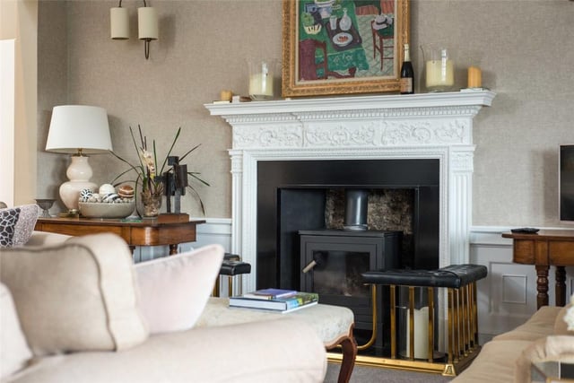 The drawing room features a fine mantelpiece with log burning stove.