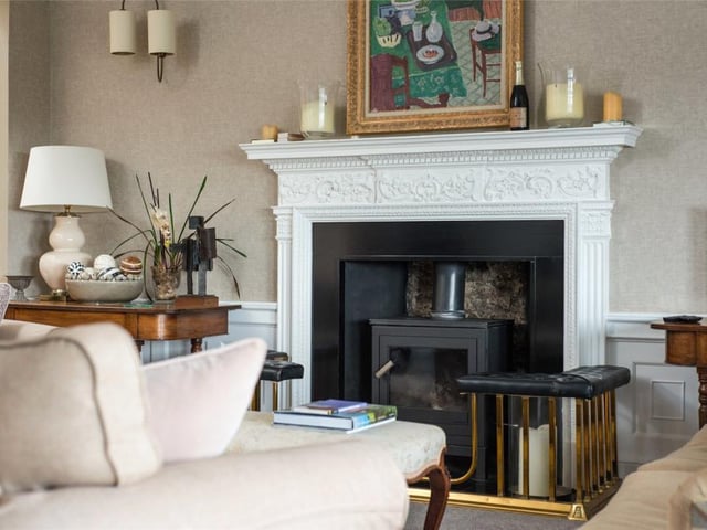 The drawing room features a fine mantelpiece with log burning stove.