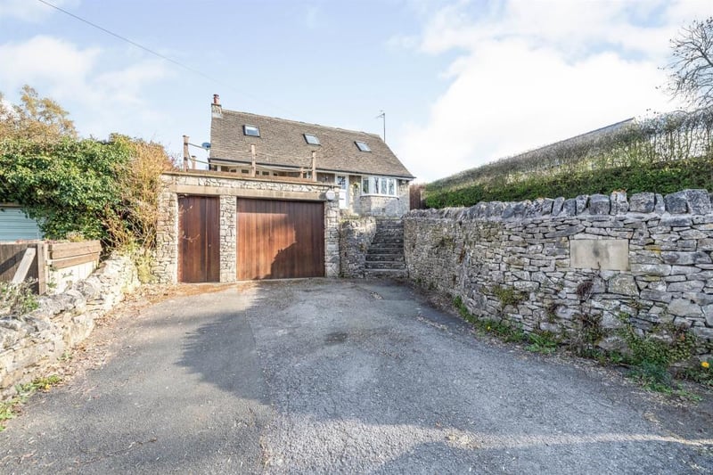 To the front of Milke Lodge is a driveway which provides access to the garage. The garage has a wooden up-and-over door, with a further door to the side, power and light.