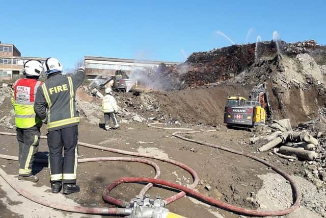 Firefighters remain at the scene of a scrap yard blaze in Sheffield today