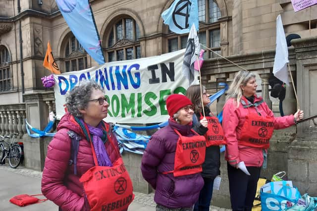 Extinction Rebellion protesters wearing life jackets outside Sheffield Town Hall to symbolise that they are 'drowning in promises' from Sheffield City Council but not concrete action to tackle climate change