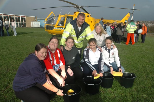 Pictured  at Newfield Comp school, Norton, where The Yorkshire Air Ambulance dropped in to have their helicopter washed by pupils who were also washing cars to raise cash for the Air Ambulance service in 2004. Seen is copter pilot Steve Beaumont with girls LtoR  Samantha Wood, Sarah Hernod, E,ily Simmons, Keeely Haythorne, Elizabeth O'Reilly, and Leigh Hopkinson
