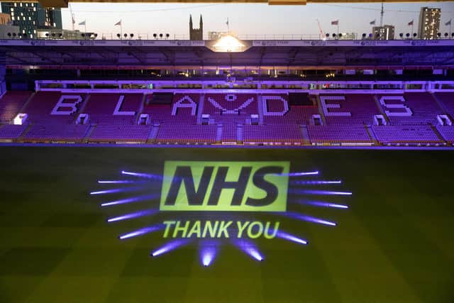 The NHS logo, beamed onto the Bramall Lane pitch