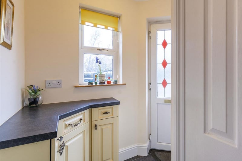 The entrance hall provides access to a WC and the kitchen.