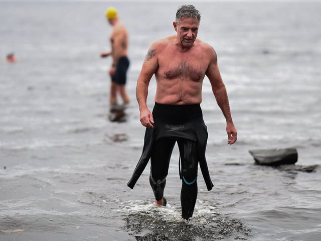 Open water swimming enthusiasts enjoy an early morning swim in Loch Lomond,Trossachs, Scotland. A new study from the UK Dementia Research Institute found that the blood of regular winter swimmers contains a "cold-shock" protein that wasn't found in that of people who did other cold-weather exercise on dry land.