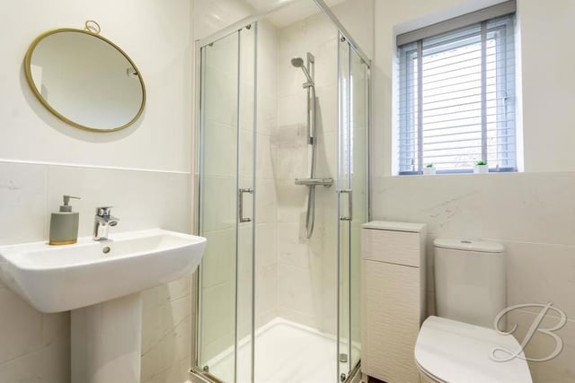 The excellent en suite to the master bedroom comes complete with a walk-in shower, low-flush WC, pedestal wash basin and opaque window to the back.
