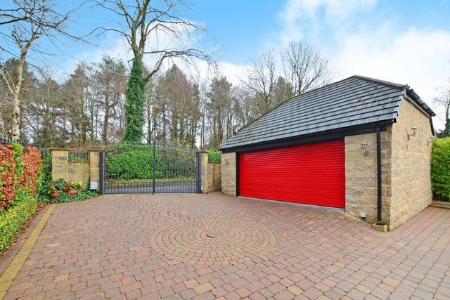 Outside there is a stone built double garage with an electric roll-up door.