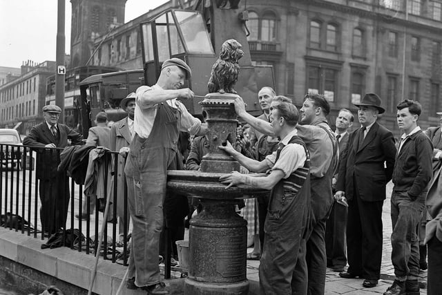 Workmen finally reinstate the much-loved statue two months after Bobby was knocked off his pedestal by a car in 1955.
