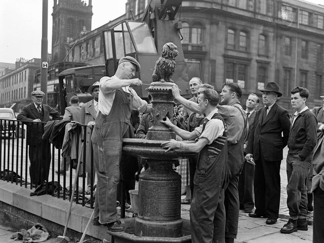 Workmen finally reinstate the much-loved statue two months after Bobby was knocked off his pedestal by a car in 1955.