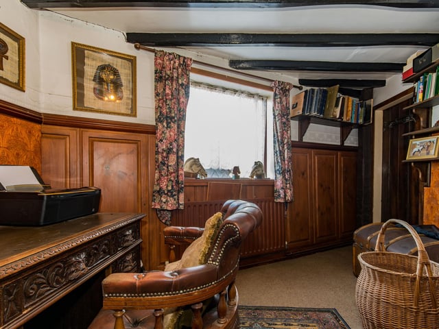The study has its own fireplace.