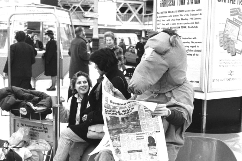 Hamish Taylor and Rob Roger dressed as a panto horse for Edinburgh Students Charities week fundraising in December 1986 - the horse reading the Evening News at Waverley station.