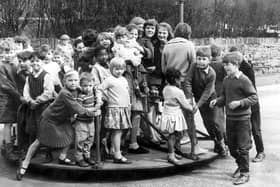 How many kids can you get on a roundabout?  Children pictured at the Countess Road playground, Sheffield April 24 ,1962