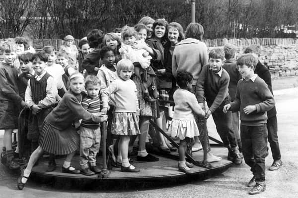 How many kids can you get on a roundabout?  Children pictured at the Countess Road playground, Sheffield April 24 ,1962