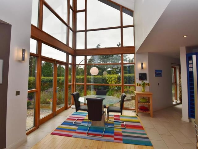 Marvel at the full-height windows in this family area, which is the perfect social space. There is a seating area, a dining area and French doors that open out to the patio at the back of the property.