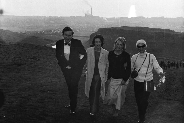 Four students are pictured climbing Arthur's Seat straight after the Edinburgh University charities ball on May Day 1965.