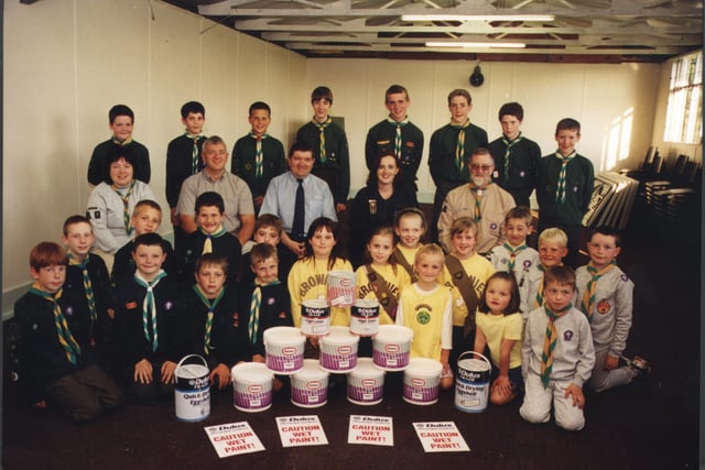 The Ici Dulux Decorator Centre in Chesterfield gave a helping hand with the refurbishment of the Dronfield District Scout and Guide Association's hut in 2001.  Members of the Scout, Guide, and Brownie groups sitting (left to right) with:  Beaver Leader Sue Rydiard, Chairman of the guidance Society Stephen Briggs, Store manager of Chesterfield's Dulux Decorator Centre James Hanson, Rainbow and Brownie Guider Sue Simpson and group Scout Leader Stewart Stenton