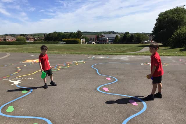 Playground markings at the school help students keep a safe distance while outside.