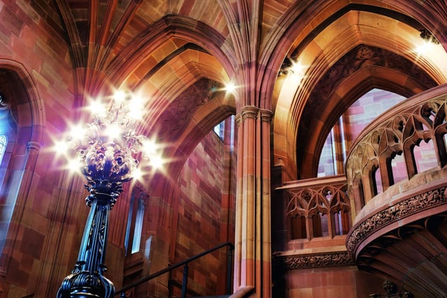 The old entrance to the John Rylands Library - designed by Basil Champneys - is architecturally stunning, featuring soaring stone vaulting, columns, a sweeping staircase and Art Nouveau light fittings. The library, off Deansgate, is filled with rare books and manuscripts and is part of the University of Manchester.