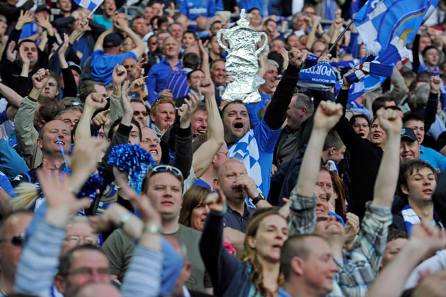 Pompey fans celebrate the 2-0 extra-time win over Spurs.