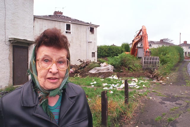 Elizabeth Harper outside her home, with demolition work in the background, on Stonecliffe Road, Manor in 1999
