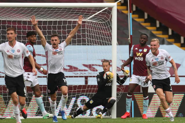 BIRMINGHAM, ENGLAND - JUNE 17: Oliver McBurnie and Jack Robinson of Sheffield United appeal for a goal which is later denied as Orjan Nyland of Aston Villa catches the ball during the Premier League match between Aston Villa and Sheffield United at Villa Park on June 17, 2020 in Birmingham, England. (Photo by Carl Recine/Pool via Getty Images)