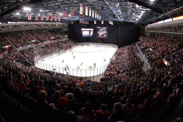 A capacity crowd watch ice hockey at Sheffield Arena.