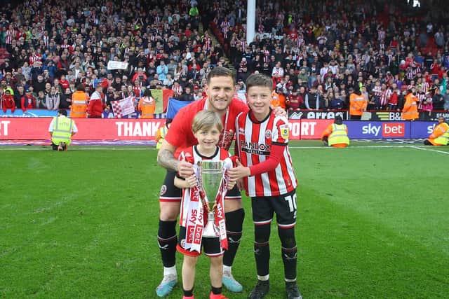 Sheffield United legend Billy Sharp with his children in front of The Kop at Bramall Lane: Simon Bellis / Sportimage