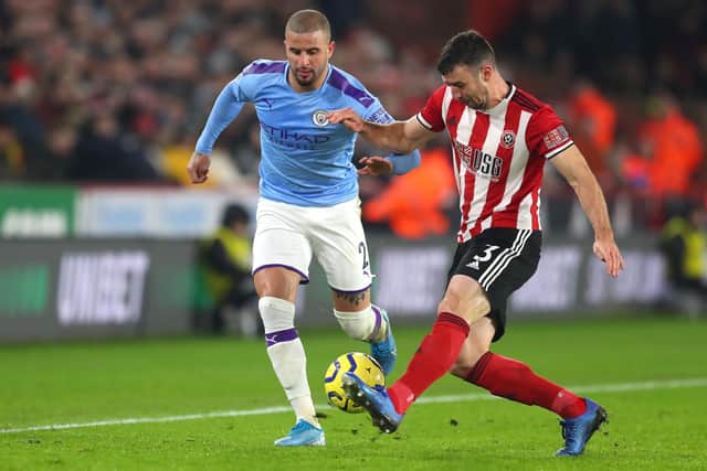 Kyle Walker of Manchester City battles for possession with Enda Stevens of Sheffield United: Catherine Ivill/Getty Images
