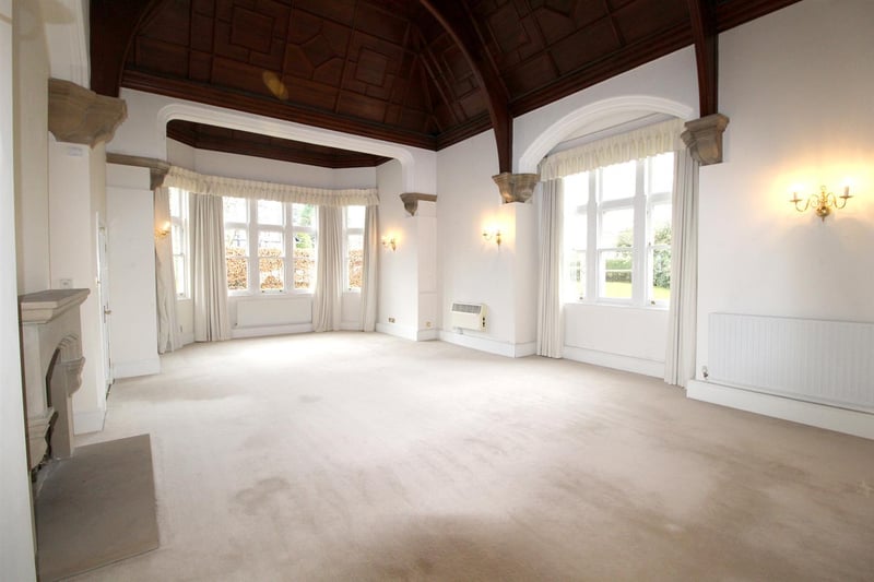 The spectacular drawing room includes a wooden panelled ceiling and a magnificent bay window.