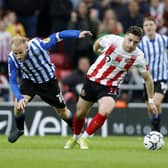 Sheffield Wednesday's Barry Bannan tumbles out of a duel with Sunderland's Lyndon Gooch.