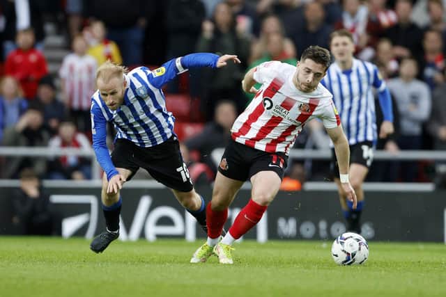 Sheffield Wednesday's Barry Bannan tumbles out of a duel with Sunderland's Lyndon Gooch.