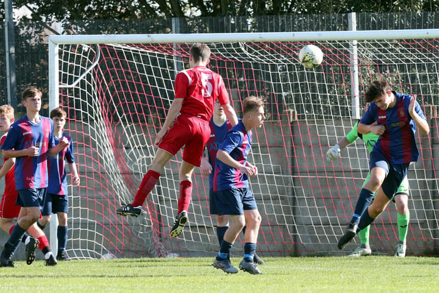 Horndean's Harry Webb (5) gets in a header at the US Portsmouth goal. Picture: Chris Moorhouse