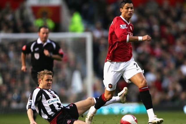 Cristiano Ronaldo of Manchester United moves away from the challenge of Derek Geary of Sheffield United (Photo by Alex Livesey/Getty Images)