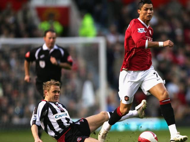 Cristiano Ronaldo of Manchester United moves away from the challenge of Derek Geary of Sheffield United (Photo by Alex Livesey/Getty Images)