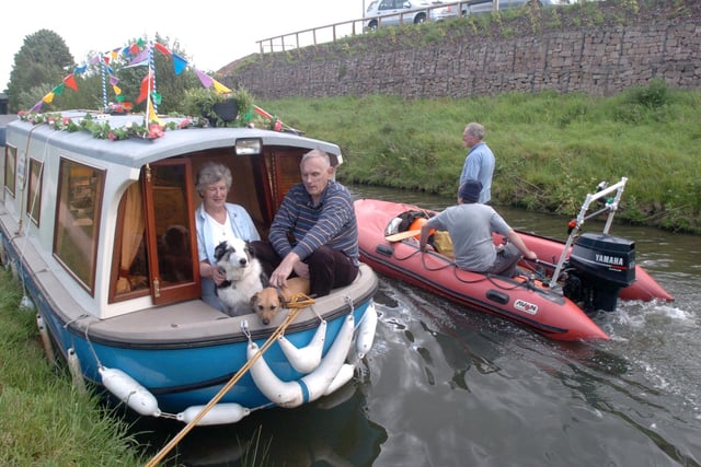 Chesterfield Canal at Tapton Lock, where the IWA National Trailboat Festival was held. Seen on their boatback in 2005 are Jim and Pauline Bell from Bolton Upon Dearne with dogs Jack and Ben.